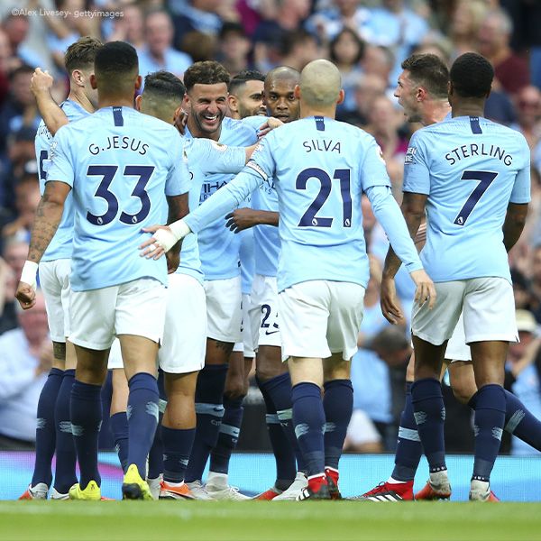 Jugadores del Manchester City celebrando un gol durante un partido de fútbol.