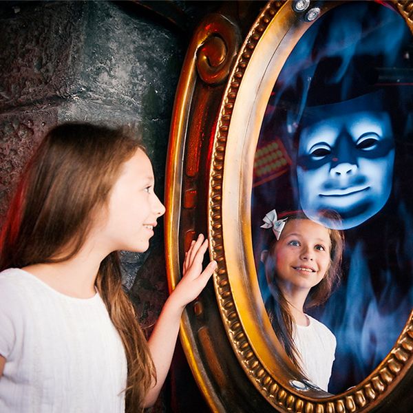 A kid having fun at Shrek Adventure's experience.